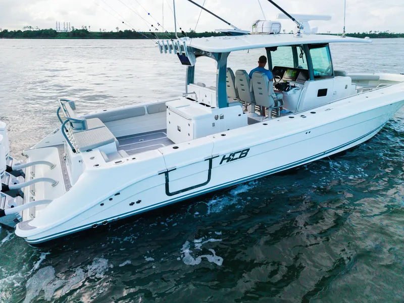 Slide: The Image of 2023 HCB 42 Lujo boat on water, featuring spacious deck and modern design. - 14