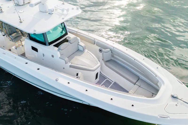 Slide: The Image of 2023 HCB 42 Lujo boat with luxurious seating on calm water. - 15