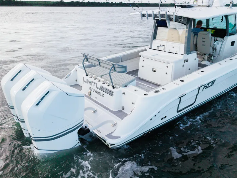 Slide: The Image of 2023 HCB 42 Lujo boat with triple engines cruising on water. - 16