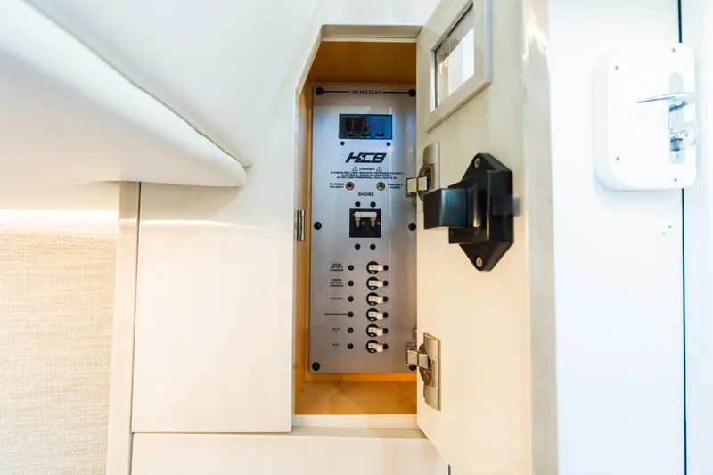 Slide: The Image of Electrical panel inside 2023 HCB 42 Lujo boat, showcasing control switches and display. - 21