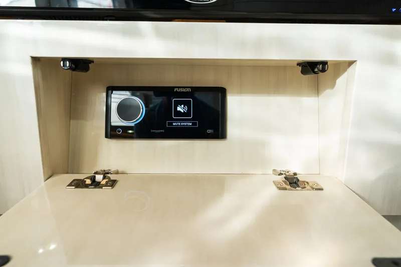 Slide: The Image of Control panel inside 2023 HCB 42 Lujo boat, featuring a Fusion audio system. - 25