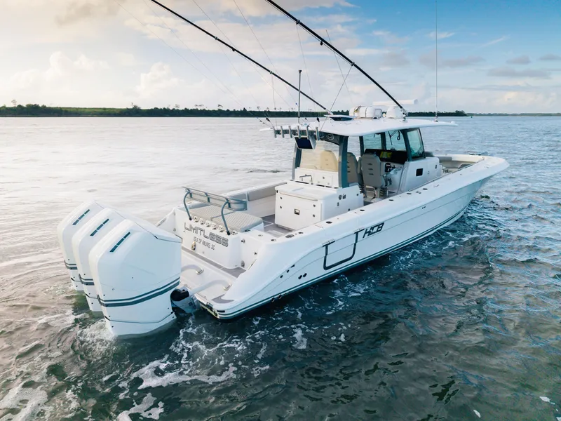 Slide: The Image of 2023 HCB 42 Lujo boat on water, featuring triple outboard engines. - 3