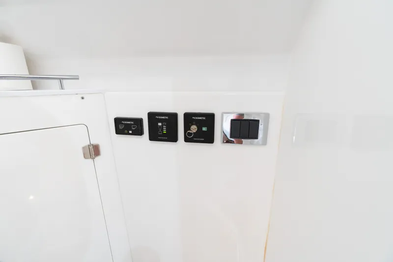 Slide: The Image of Control panel on 2023 HCB 42 Lujo boat interior, featuring Dometic switches. - 30