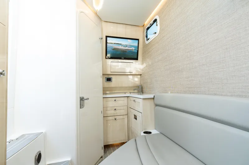 Slide: The Image of Interior of 2023 HCB 42 Lujo boat with modern seating and compact kitchenette. - 36