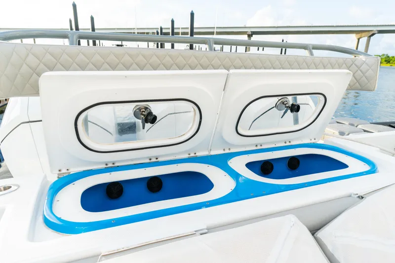 Slide: The Image of 2023 HCB 42 Lujo boat with open storage compartments, featuring blue interiors and sleek design. - 43