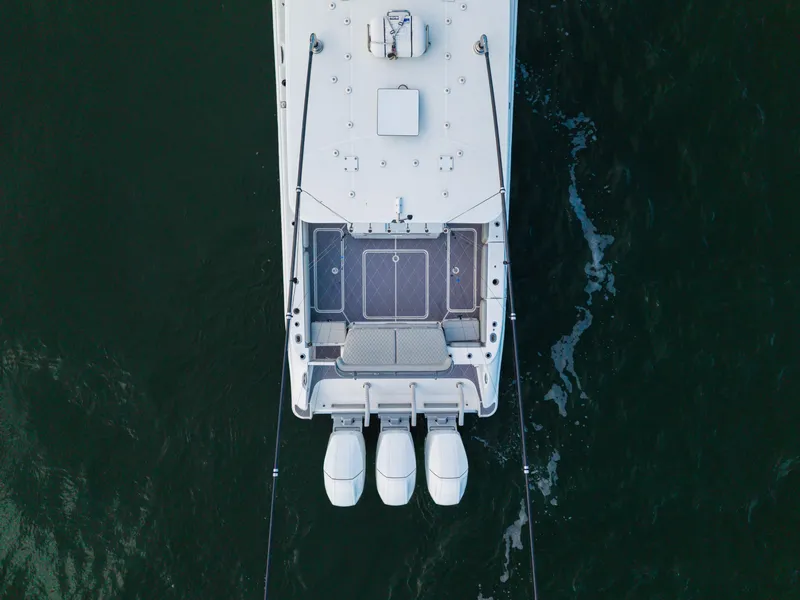 Slide: The Image of Aerial view of 2023 HCB 42 Lujo boat with triple outboard engines. - 44