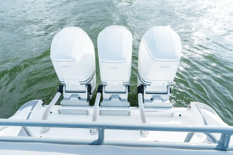 Slide: The Image of Triple outboard engines on 2023 HCB 42 Lujo boat, cruising on water. - 49