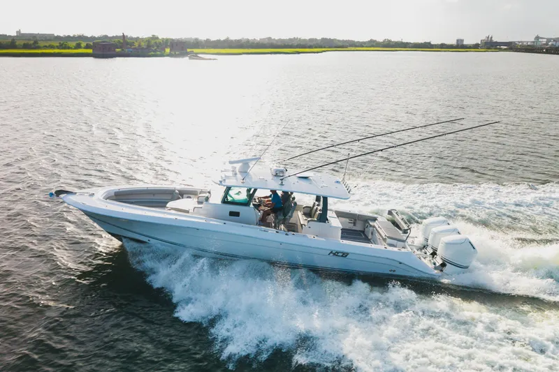 Slide: The Image of 2023 HCB 42 Lujo boat cruising on open water, showcasing sleek design and powerful engines. - 6