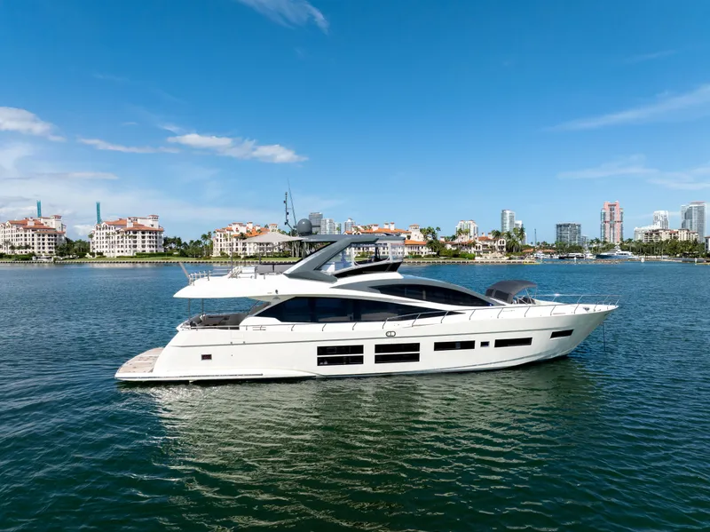 Slide: The Image of Luxury 2016 Astondoa 80 GLX yacht cruising on a sunny day near coastal cityscape. - 16