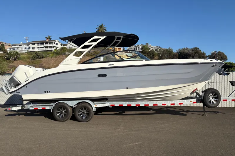 The Image of 2026 Sea Ray SDX 270 Outboard boat on trailer, parked outdoors. - 0