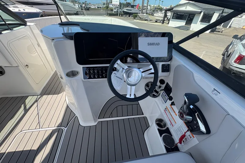 Slide: The Image of 2026 Sea Ray SDX 270 Outboard helm with Simrad display and modern controls. - 10