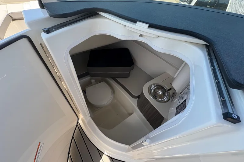 Slide: The Image of 2026 Sea Ray SDX 270 Outboard boat interior with compact bathroom amenities. - 11