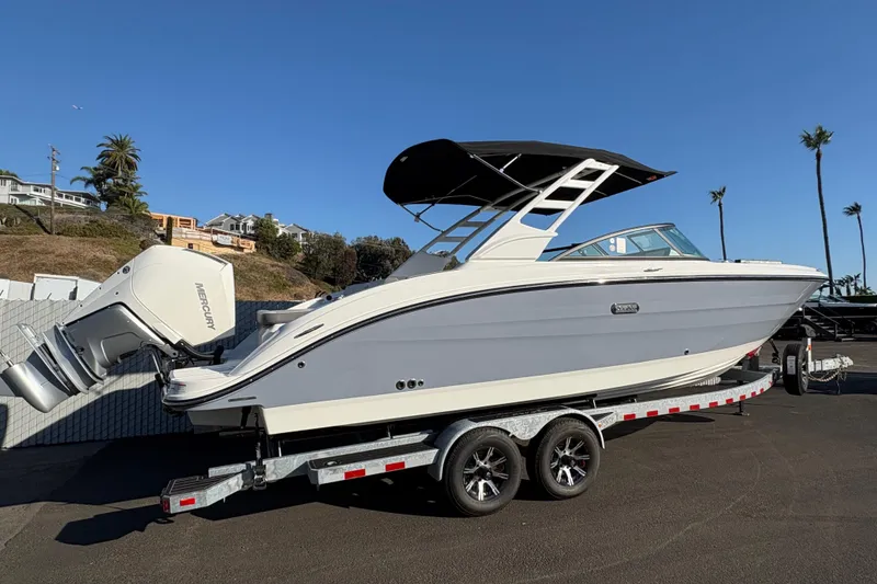 Slide: The Image of 2026 Sea Ray SDX 270 Outboard boat on trailer, sunny day, palm trees in background. - 2