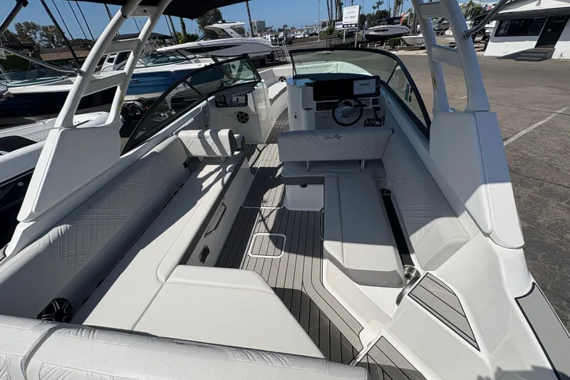 Slide: The Image of 2026 Sea Ray SDX 270 Outboard boat interior with sleek seating and modern dashboard. - 5
