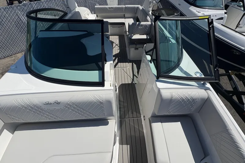 Slide: The Image of 2026 Sea Ray SDX 270 Outboard boat interior with white seating and open windshield. - 7