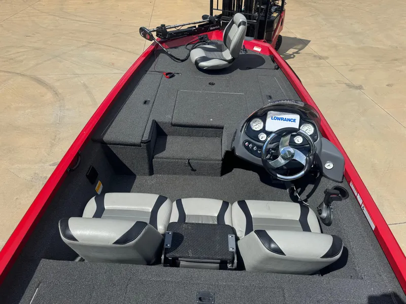 Slide: The Image of 2014 Lowe Stinger 18 HP boat interior with steering console and seating. - 3