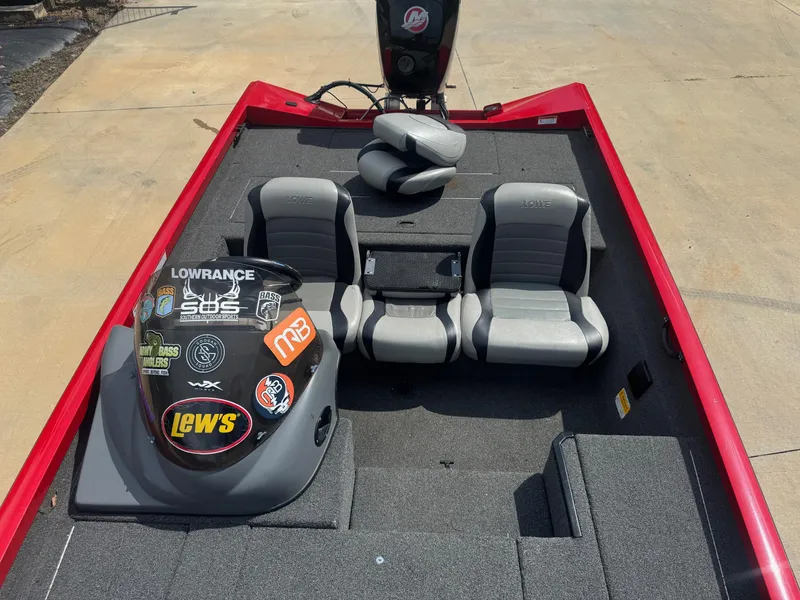 Slide: The Image of 2014 Lowe Stinger 18 HP boat interior with gray seats and sticker-covered console. - 5