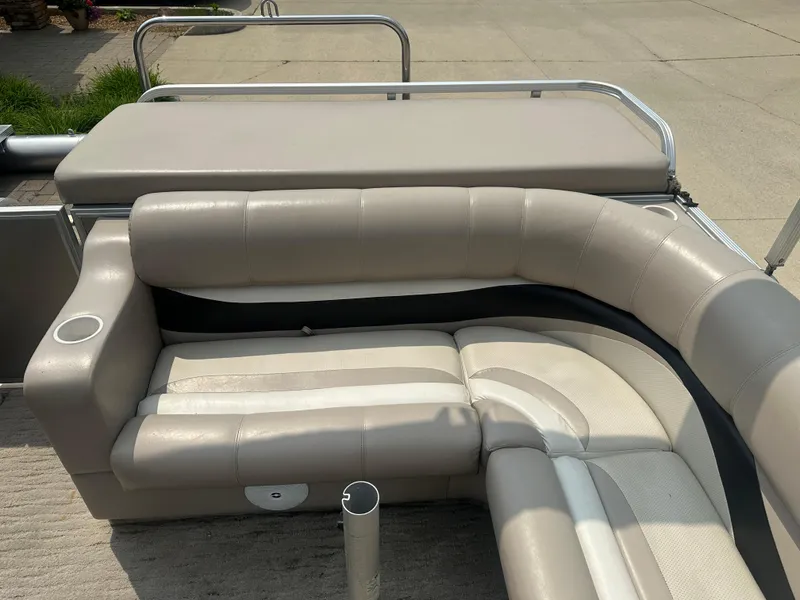 Slide: The Image of 2010 Crest II LM 22 boat interior with beige cushioned seating. - 10