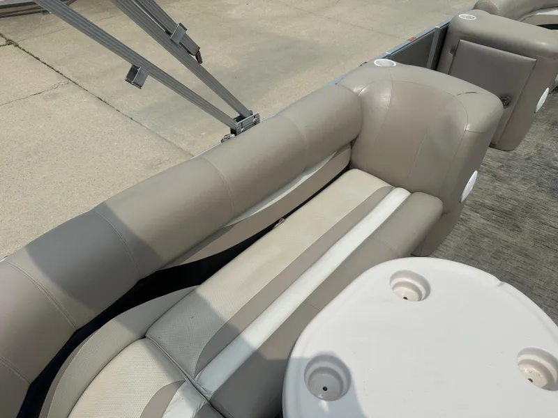 Slide: The Image of 2010 Crest II LM 22 boat interior with beige seating and round table. - 13