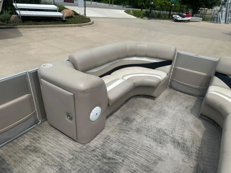 Slide: The Image of 2010 Crest II LM 22 pontoon boat interior with beige seating and carpeted floor. - 14