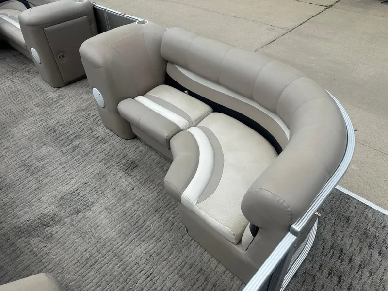 Slide: The Image of 2010 Crest II LM 22 pontoon boat seating with beige upholstery and curved design. - 4