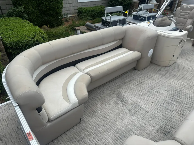 Slide: The Image of 2010 Crest II LM 22 pontoon boat with beige seating and helm. - 5