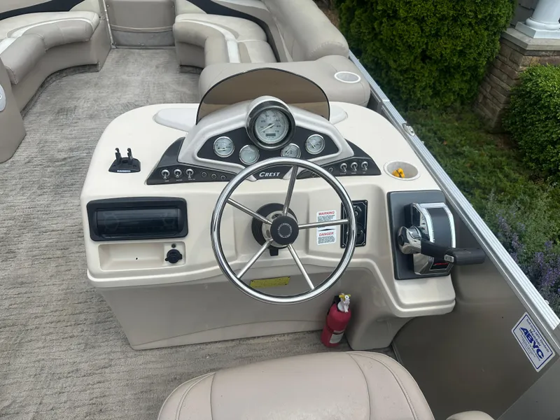 Slide: The Image of Steering console of a 2010 Crest II LM 22 pontoon boat with gauges and controls. - 8