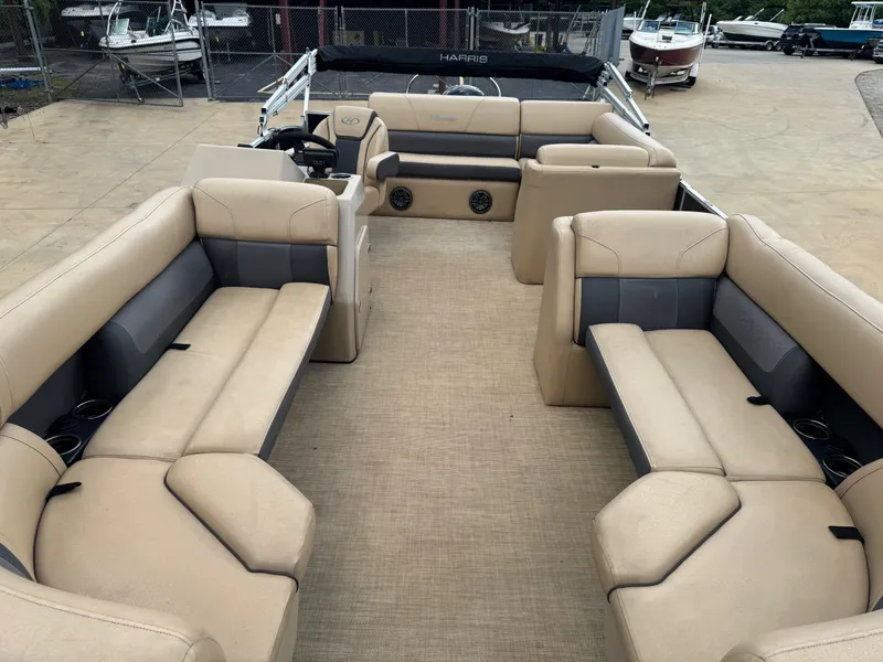 Slide: The Image of 2022 Harris Cruiser 230 pontoon boat interior with beige and gray seating. - 7