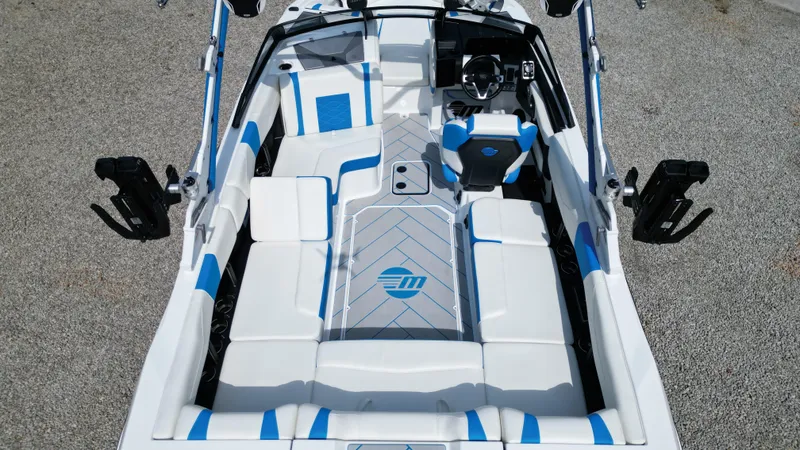 Slide: The Image of 2025 Malibu Wakesetter 23 LSV interior, featuring sleek white and blue seating design. - 11