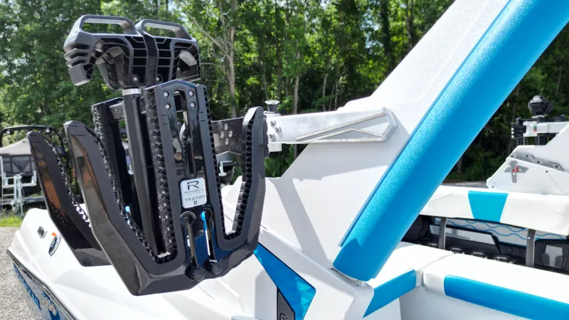 Slide: The Image of 2025 Malibu Wakesetter 23 LSV boat with wakeboard rack, blue and white design. - 20