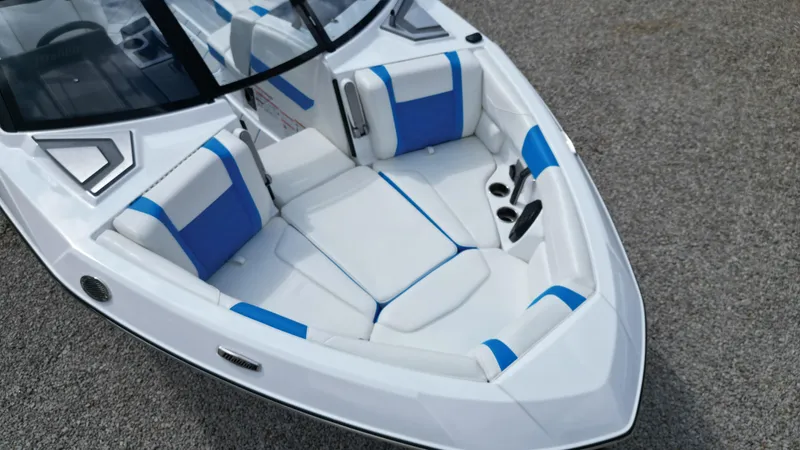 Slide: The Image of 2025 Malibu Wakesetter 23 LSV boat interior with white and blue seating. - 7