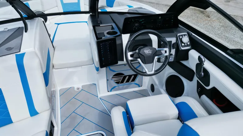 Slide: The Image of 2025 Malibu Wakesetter 23 LSV interior with modern dashboard and blue-accented seating. - 9