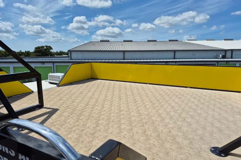 Slide: The Image of 2021 Bahama 240 Tritoon Coral Reef with Mercury outboard motor in parking lot. - 11