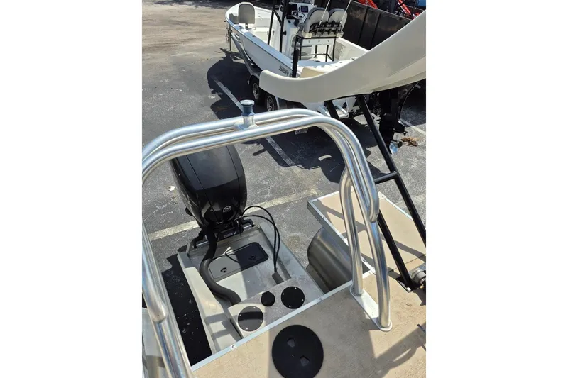 Slide: The Image of 2021 Bahama 240 Tritoon Coral Reef deck with yellow railing under blue sky. - 12