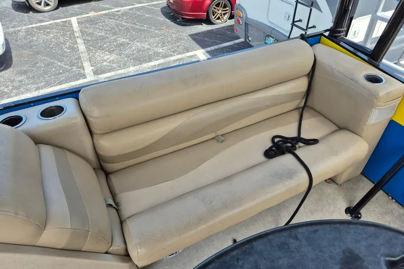 Slide: The Image of Beige seating on 2021 Bahama 240 Tritoon Coral Reef boat, featuring cup holders and armrests. - 14