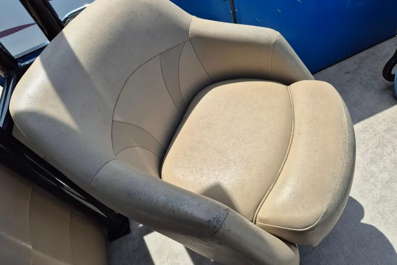 Slide: The Image of Steering console of 2021 Bahama 240 Tritoon Coral Reef boat with gauges and controls. - 16