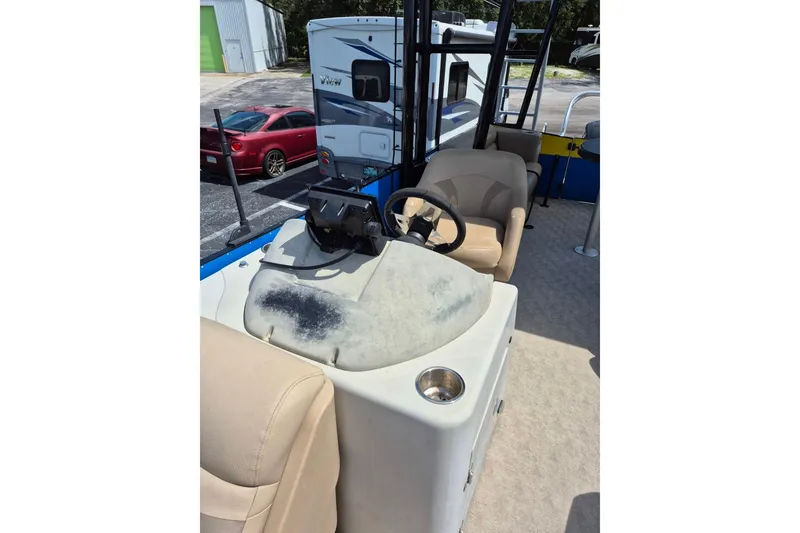 Slide: The Image of Beige seating on 2021 Bahama 240 Tritoon Coral Reef boat, with cup holders. - 19