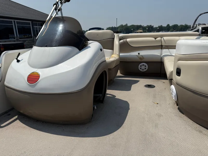 Slide: The Image of 2000 Sun Tracker PARTY BARGE 25 interior with beige seating and steering console. - 10