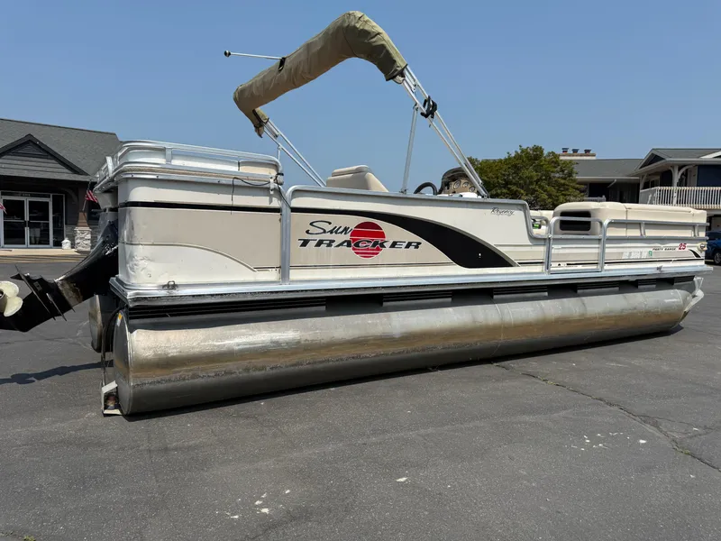 Slide: The Image of 2000 Sun Tracker PARTY BARGE 25 pontoon boat parked on pavement. - 3