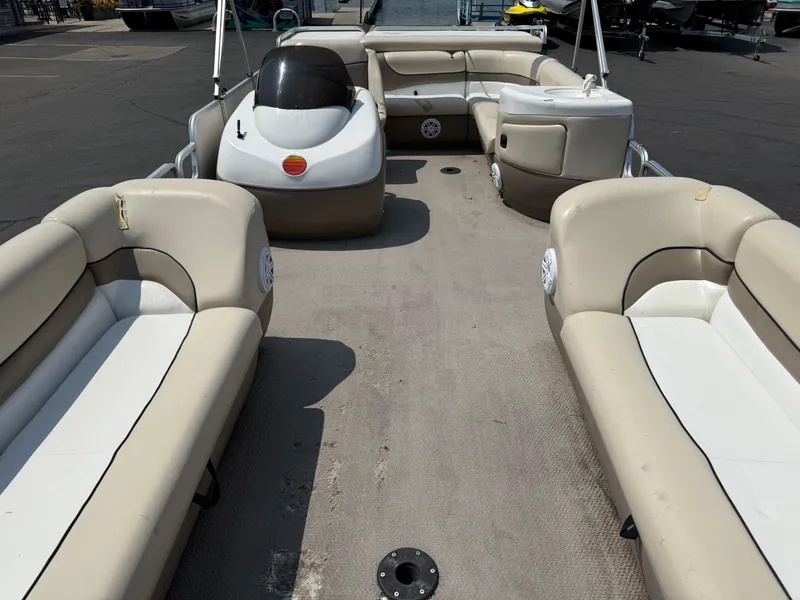 Slide: The Image of 2000 Sun Tracker PARTY BARGE 25 pontoon boat interior with beige seating and helm. - 9