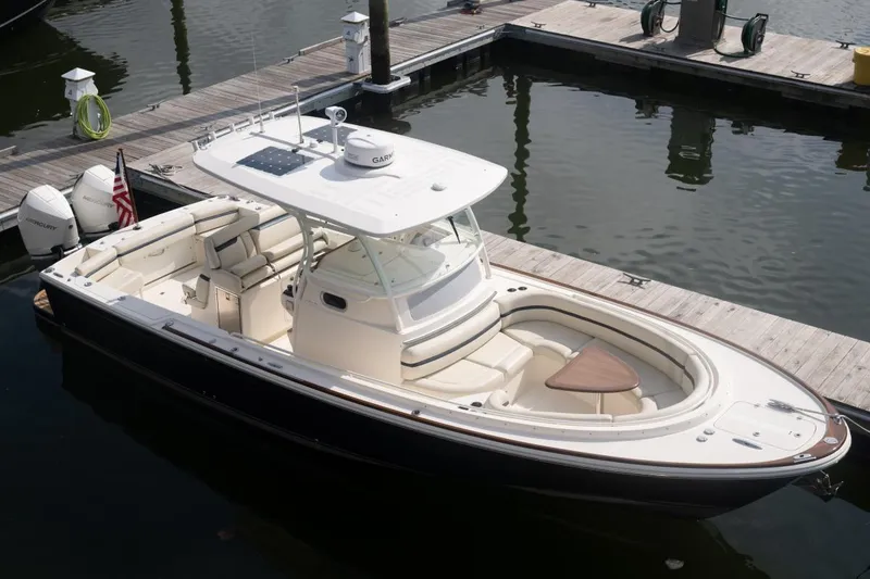 Slide: The Image of 2019 Hunt Yachts 32 Center Console docked, featuring sleek design and spacious seating. - 11