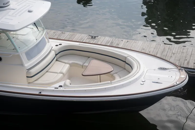 Slide: The Image of 2019 Hunt Yachts 32 Center Console docked, featuring spacious seating and elegant design. - 12