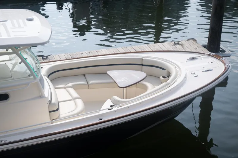 Slide: The Image of 2019 Hunt Yachts 32 Center Console docked, featuring sleek design and comfortable seating. - 13