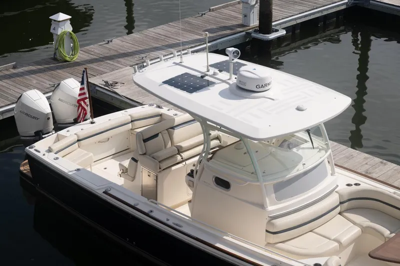 Slide: The Image of 2019 Hunt Yachts 32 Center Console docked, featuring dual Mercury engines and sleek design. - 14