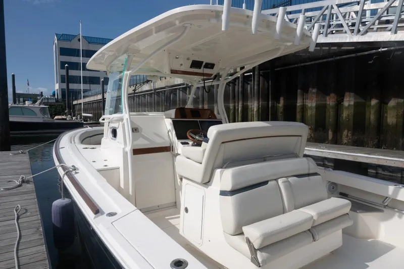Slide: The Image of 2019 Hunt Yachts 32 Center Console docked, showcasing sleek design and spacious seating. - 19