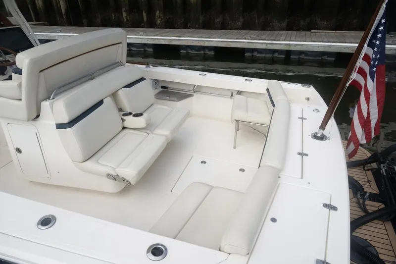 Slide: The Image of 2019 Hunt Yachts 32 Center Console with white seating and American flag. - 20