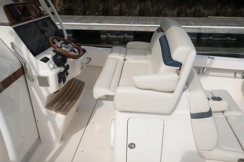 Slide: The Image of 2019 Hunt Yachts 32 Center Console interior with white seating and wooden steering wheel. - 22