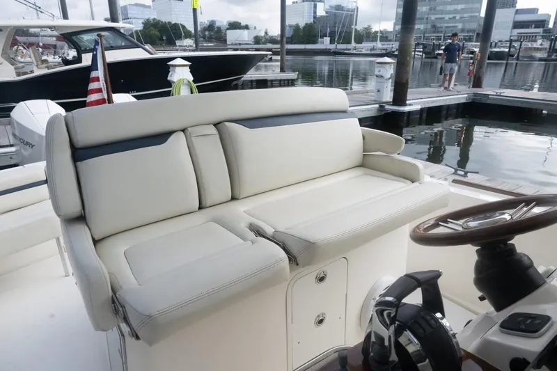 Slide: The Image of 2019 Hunt Yachts 32 Center Console with plush seating at marina dock. - 23