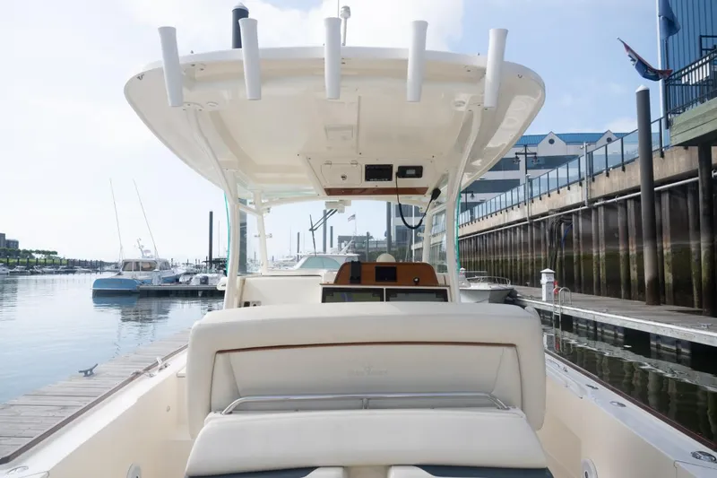 Slide: The Image of 2019 Hunt Yachts 32 Center Console docked at marina, showcasing helm and seating area. - 24