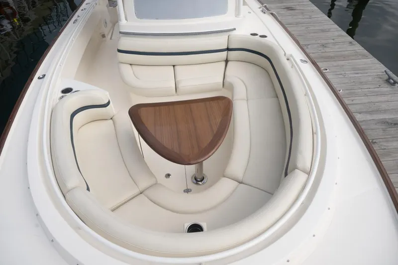 Slide: The Image of 2019 Hunt Yachts 32 Center Console with elegant seating and wooden table. - 25